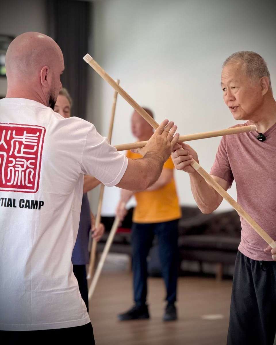 The Martial Man founder practising a stick drill with a partner at a past camp